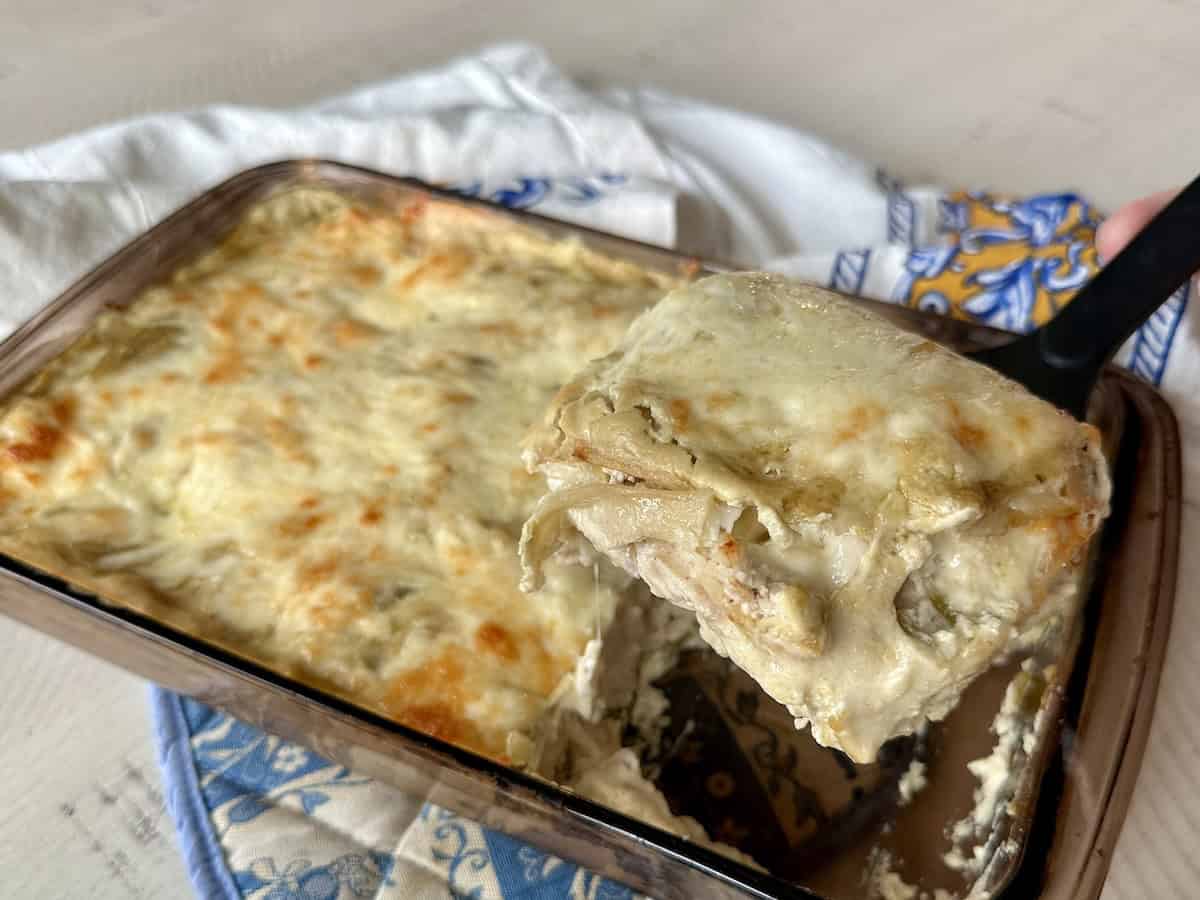 large piece of enchilada casserole on spatula