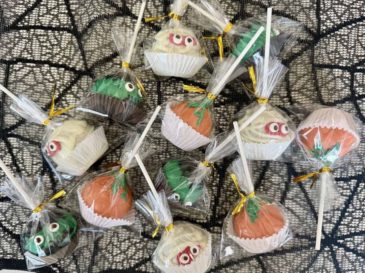wrapped halloween cake pops on spider web table runner