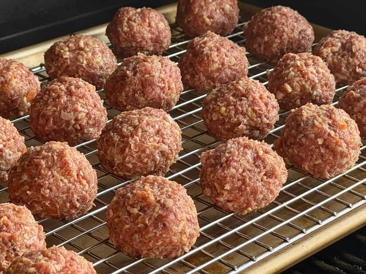 uncooked meatballs on smoker