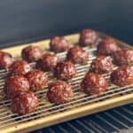smoked meatballs on sheet pan with wire rack on pellet smoker
