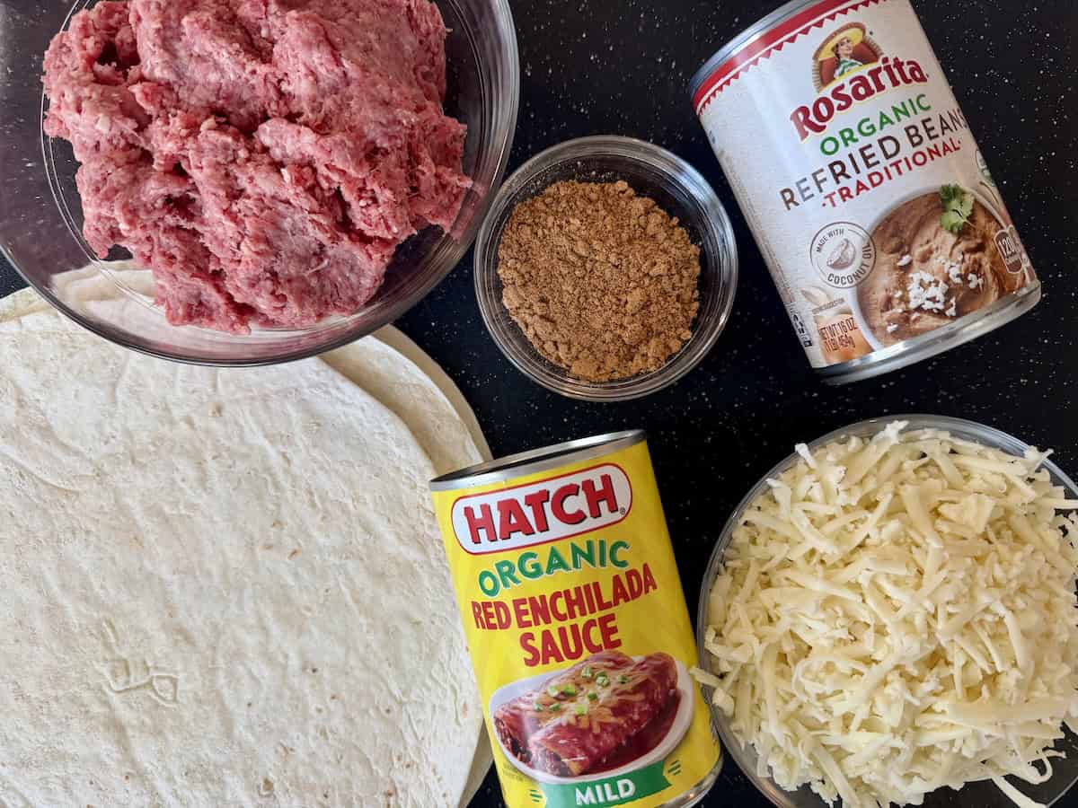 beef burrito ingredients on black cutting board