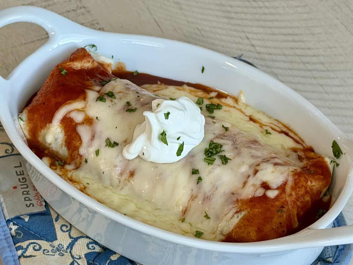 wet beef burrito in white baking dish