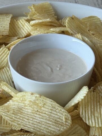 beefy onion dip in white bowl ruffle potato chips
