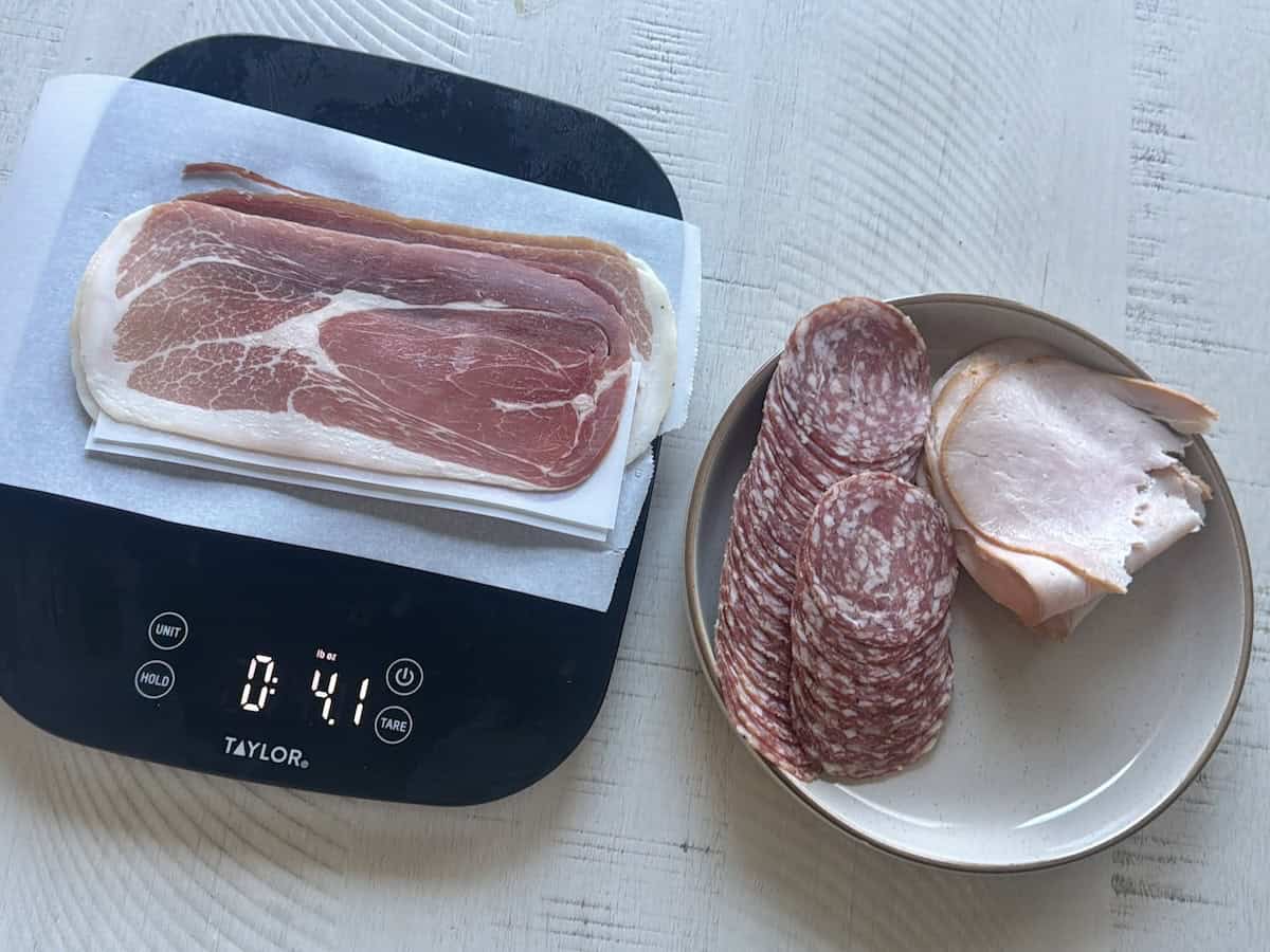 food scale with prosciutto tan plate salami and turkey