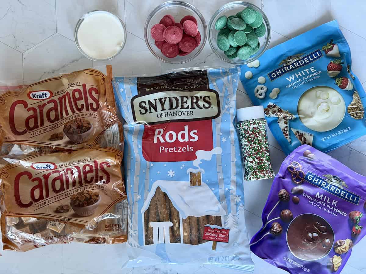 2 bags of caramel bag of pretzel rods white chocolate milk chocolate red and green candy melts and heavy cream