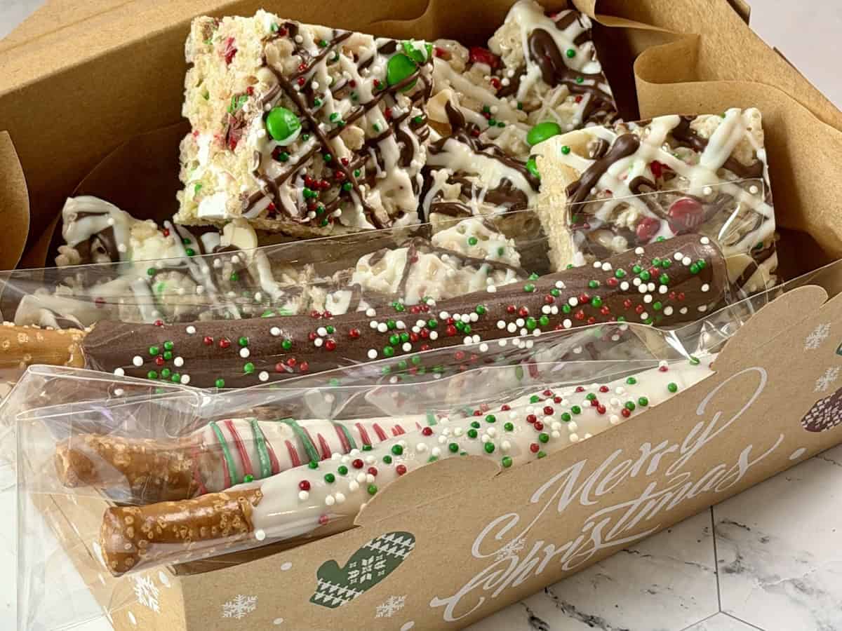 rice Krispie treats and chocolate pretzels in christmas cookie box