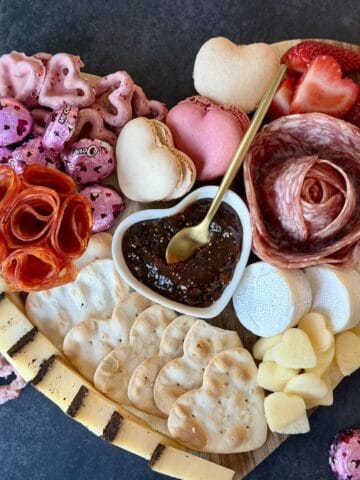 heart shaped charcuterie board cheese meat flowers macarons brie fig spread gold spoon