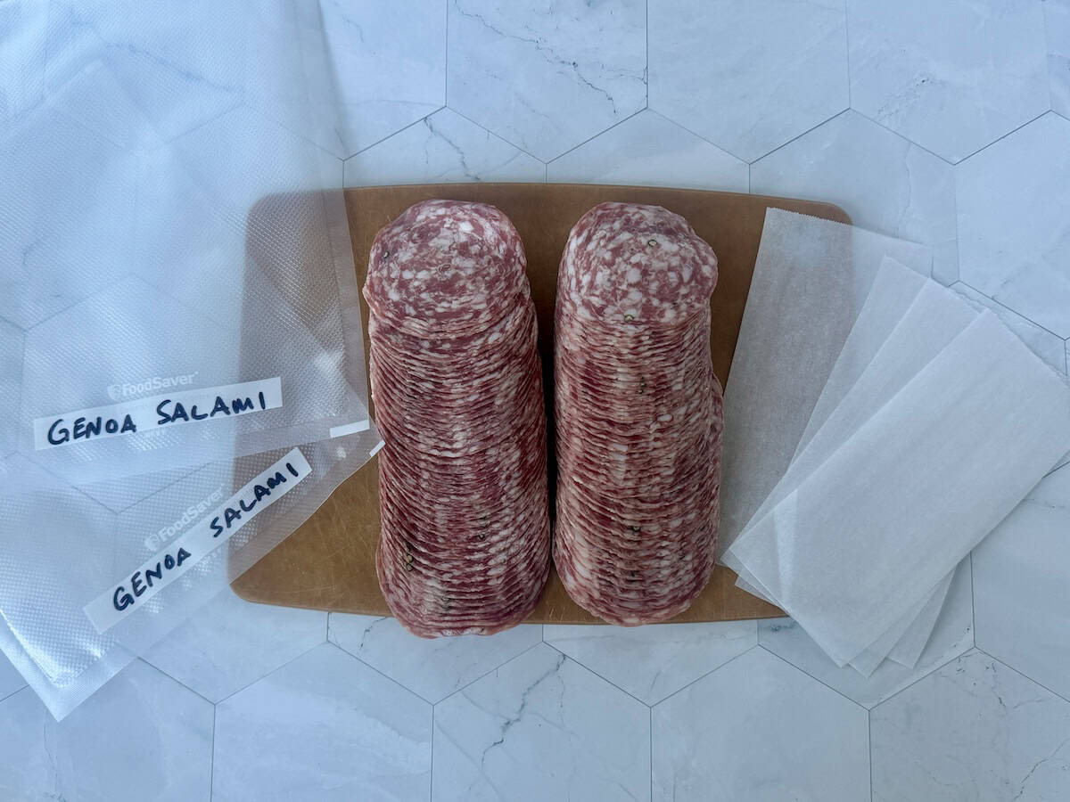 2 food saver sleeves two stacks of salmi brown cutting board strips of parchment