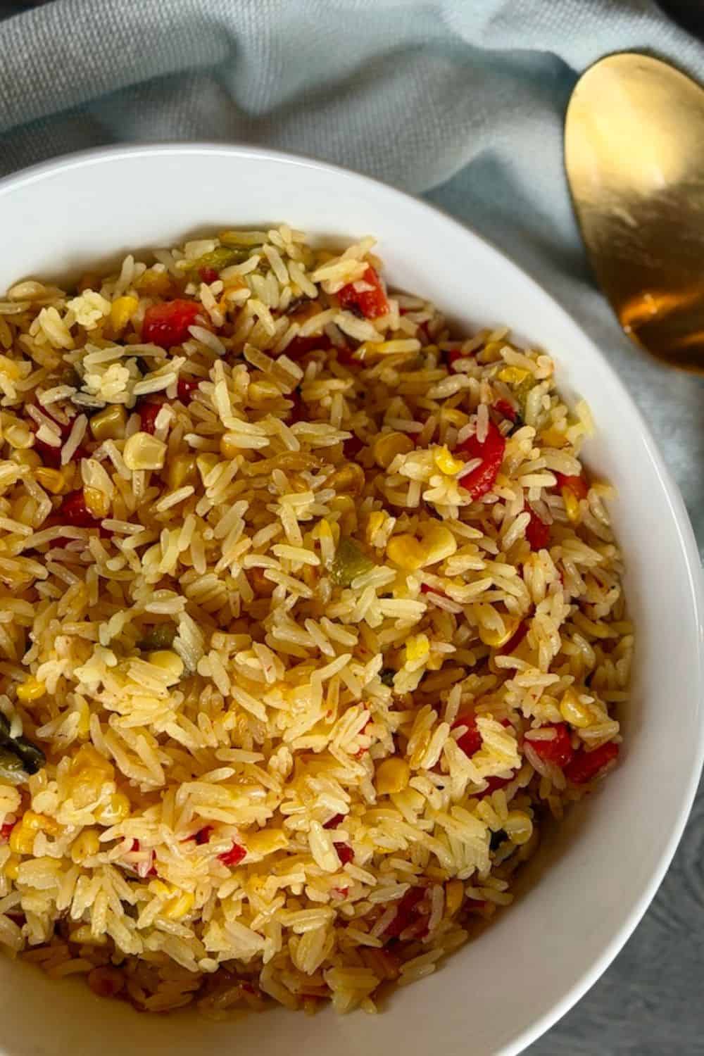 white bowl saffron and roasted pepper rice gold spoon green towel