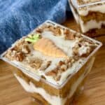 carrot cake layered in clear cups wood cutting board blue napkin