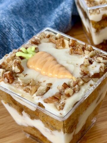 carrot cake layered in clear cups wood cutting board blue napkin