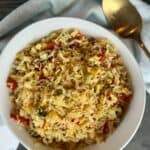 white bowl saffron and roasted pepper rice gold spoon green towel