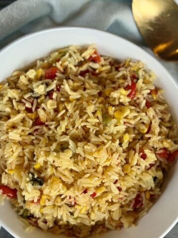 white bowl saffron and roasted pepper rice gold spoon green towel