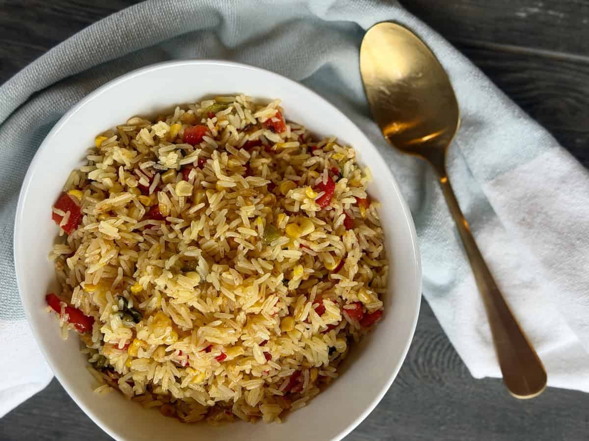white bowl saffron and roasted pepper rice gold spoon green towel