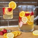 strawberry citrus sangria in a glass pitcher glass of sangria cut strawberries oranges lemons