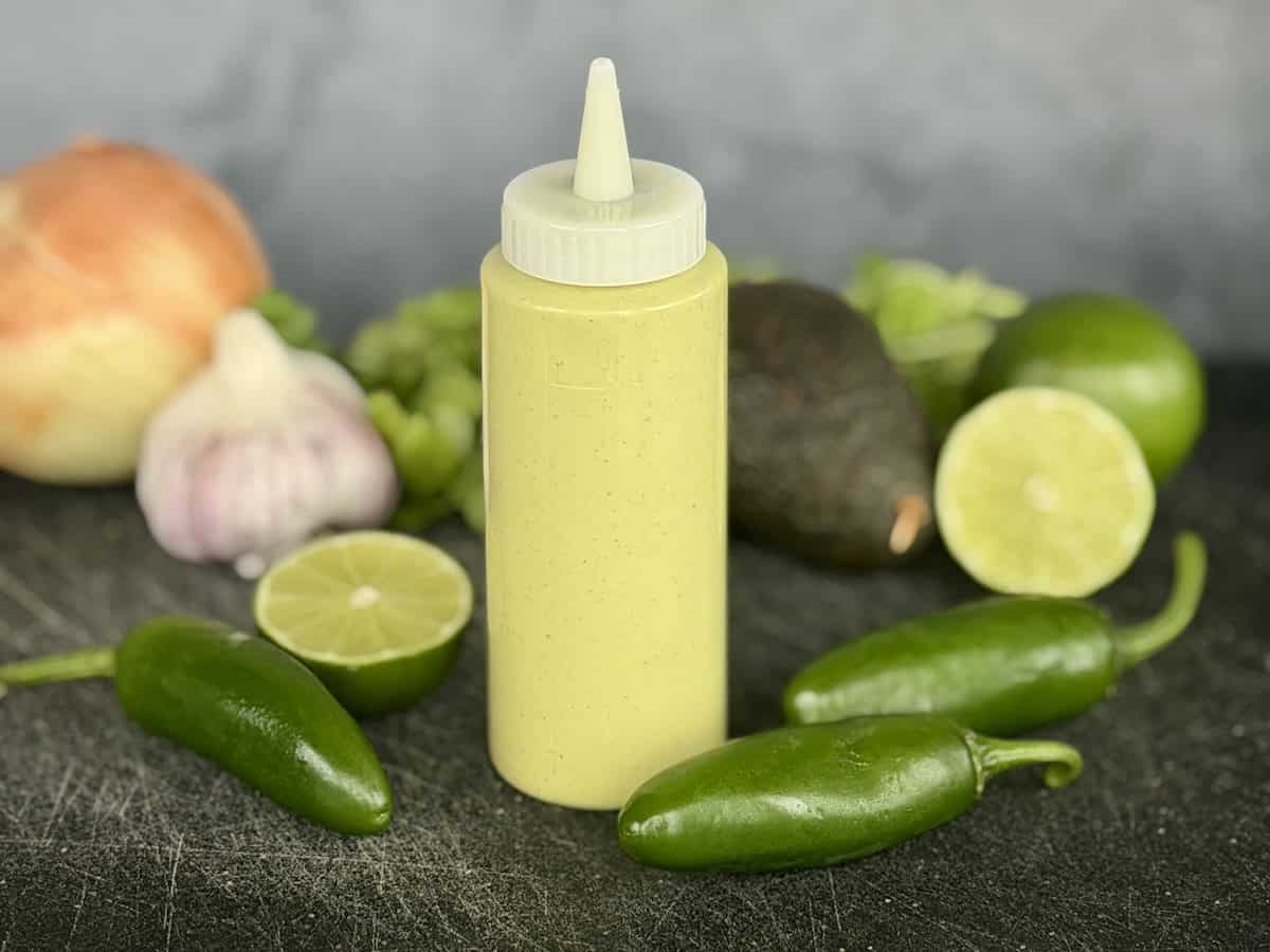 green taco sauce in squeeze bottle whole jalapenos lime garlic onion avocado