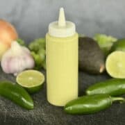 green taco sauce in squeeze bottle whole jalapenos lime garlic onion avocado