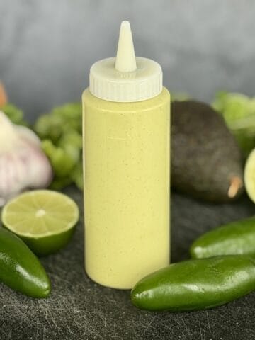 green taco sauce in squeeze bottle whole jalapenos lime garlic onion avocado