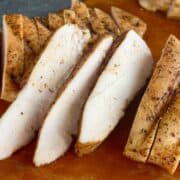 sliced traeger chicken breast on wood cutting board