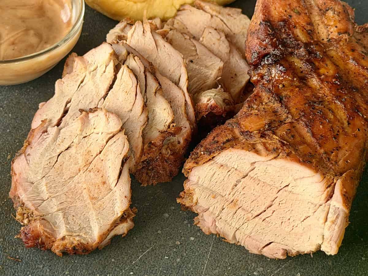 think sliced pork tenderloin and whole pork tenderloin roast black cutting board