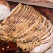 sliced smoked turkey breast on pink butcher paper