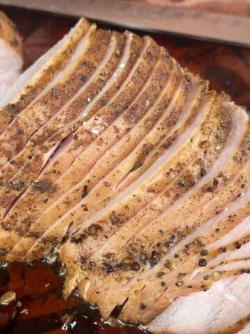 sliced smoked turkey breast on pink butcher paper