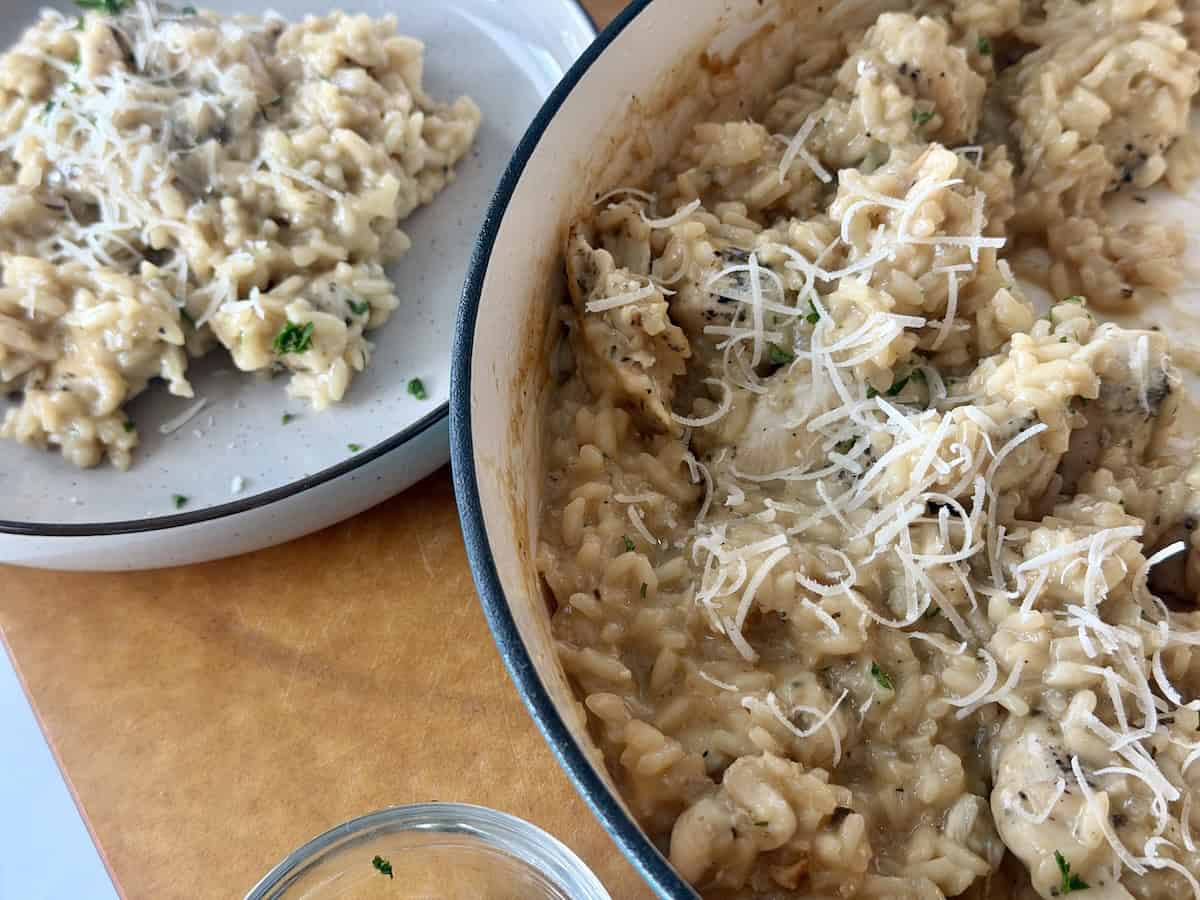 chicken marsala risotto in teal pot plate of served risotto wood cutting board