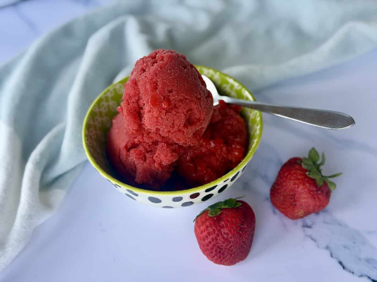 homemade strawberry sorbet in green bowl with spoon