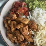 chipotle chicken with rice, guacamole, and pico de Gallo in a bowl