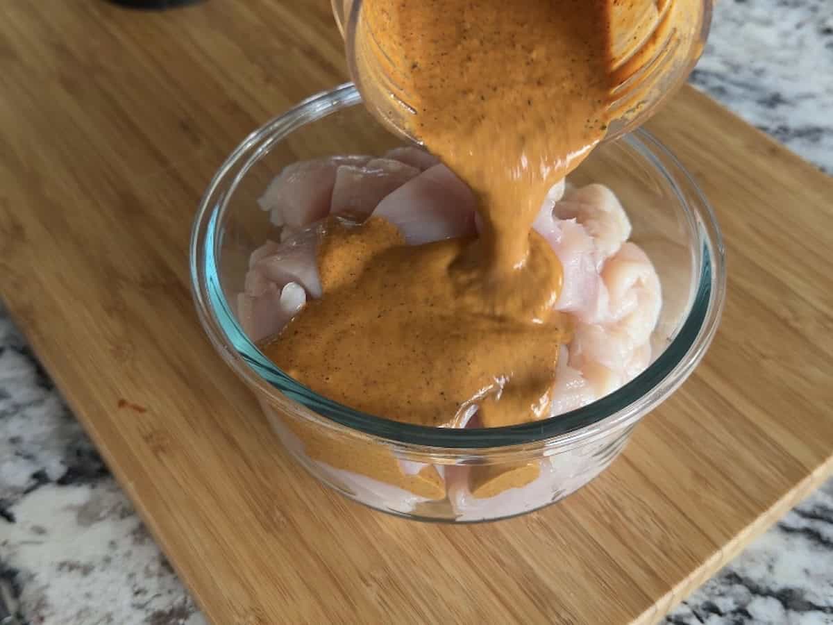 chipotle marinade pouring over chicken